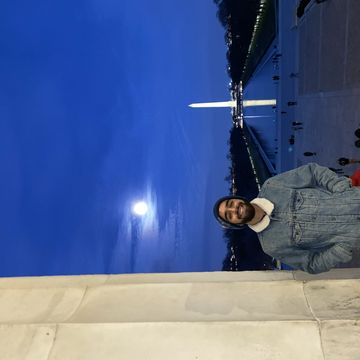 Cameron Mirhossaini in front of the reflecting pool in Washington D.C. 